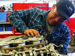 A student working on a car engine.