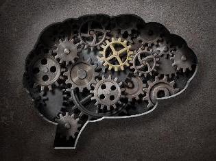The silhouette of a human brain with cogs and gears filled in.
